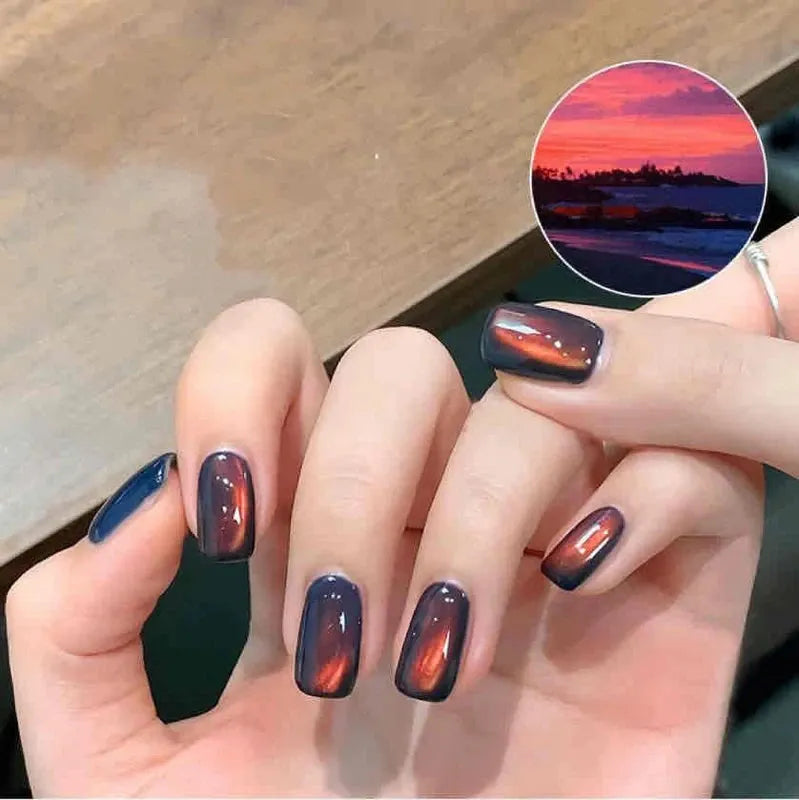 SUN 01 Sea Sunset cat eye gel magnetic cat eye gel polish featuring a warm orange and pink gradient with a luminous 3D nail effect, shimmering particles, and reflective nail design for a radiant professional gel manicure with sunset-inspired depth and glow.